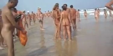 Asian babes relaxing on the beach get a boob sharking.